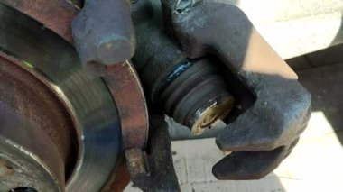 broken brake piston. Car disc brake repair. Vehicle service. Replacing parts by a mechanic