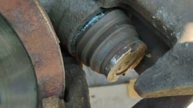 broken brake piston. Car disc brake repair. Vehicle service. Replacing parts by a mechanic