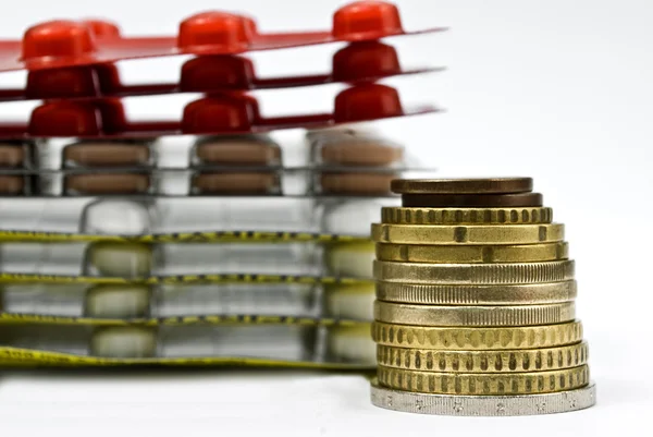 Stack of money and medicines as healthcare concept — Stock Photo, Image