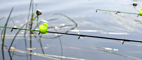 Feeder method in fishing and bells on the rods tips — Stock Photo, Image