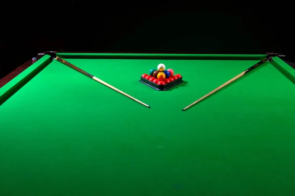 pool table with cues and balls