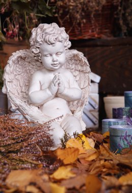 Angel figurine still life in autumn leaves