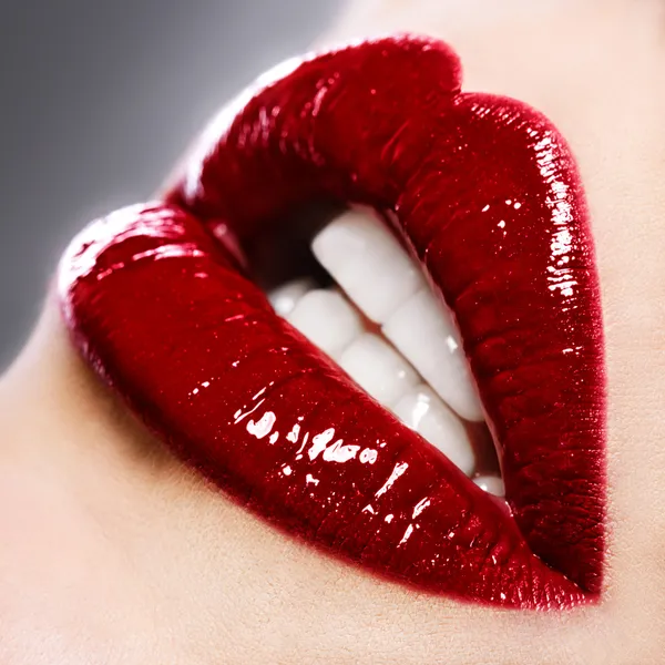 Beautiful female with red shiny lips close up Stock Photo