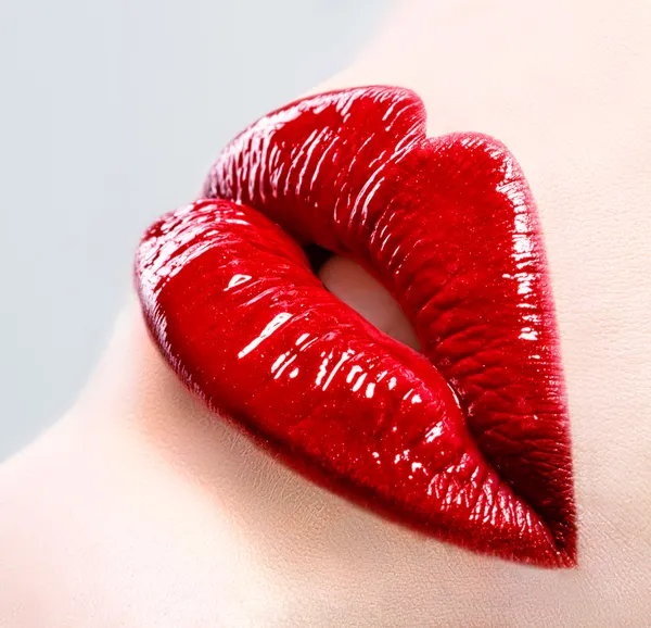 Beautiful female with red shiny lips close up Royalty Free Stock Images