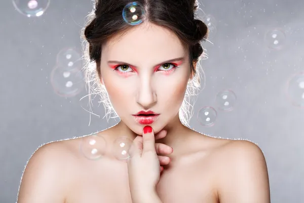 Portrait of a beautiful woman with soap bubbles — Stock Photo, Image