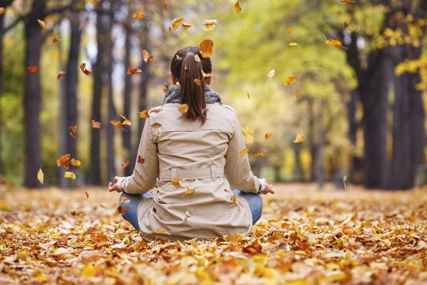 Woman meditator in the autumn park — Stock Photo, Image