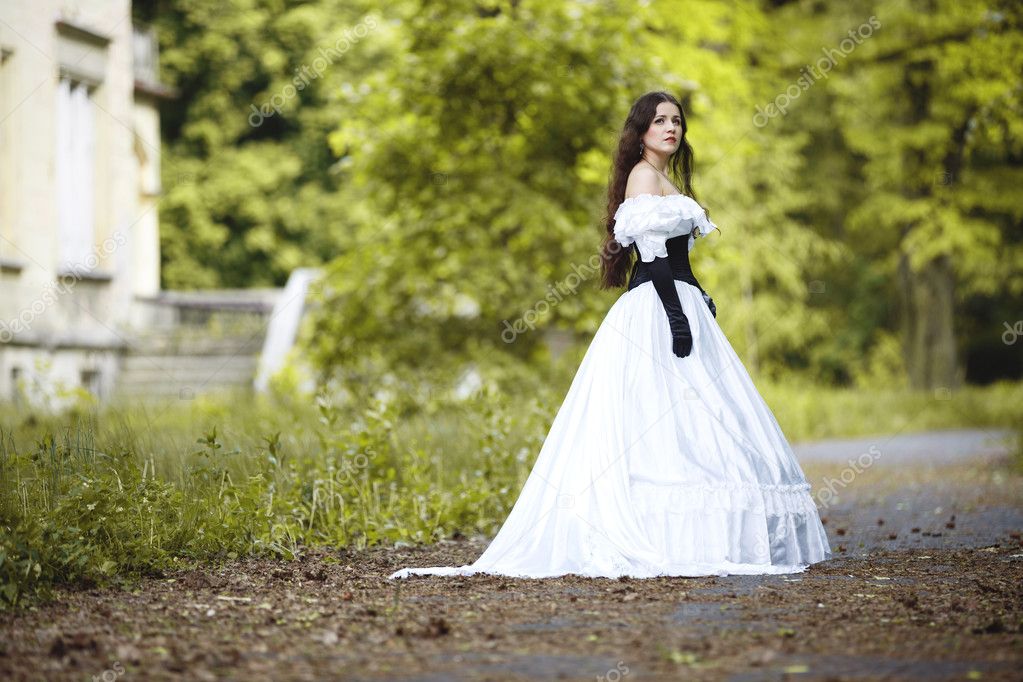 Mysterious woman in a white Victorian dress