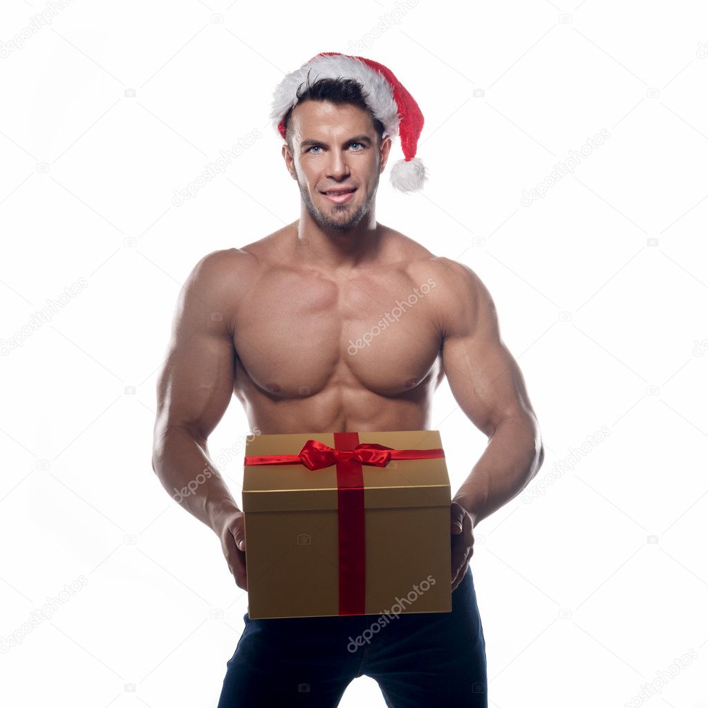 Muscular, sexy santa claus with gift