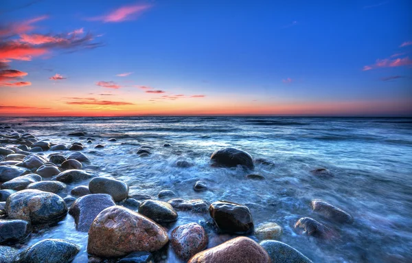 Pôr do sol sobre o mar Báltico. A praia de seixos em Rozewie — Fotografia de Stock