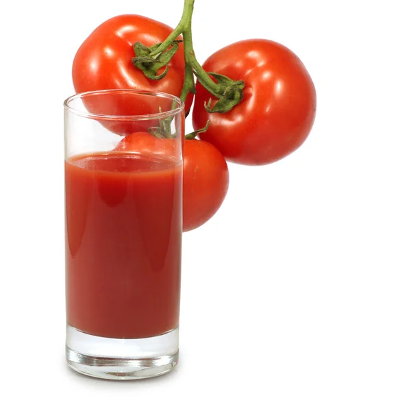 Стакан сока и помидоров — стоковое фото