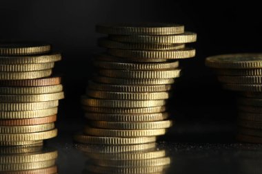 A vertical shot of a pile of golden coins and copper coins.