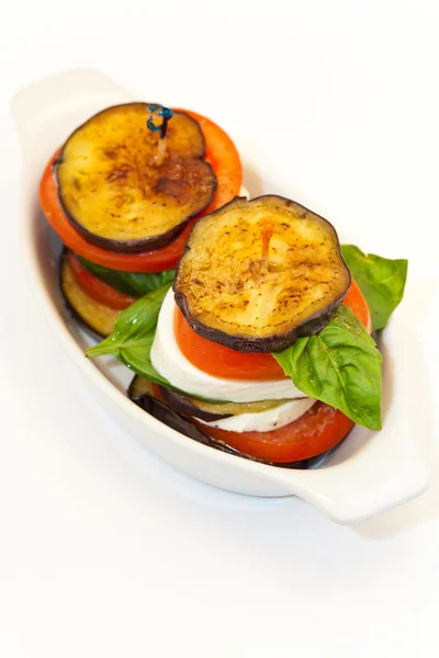 Eggplant with mozzarella cheese, tomatoes and basil — Stock Photo, Image