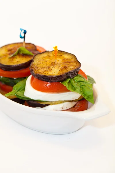 Eggplant with mozzarella cheese, tomatoes and basil — Stock Photo, Image