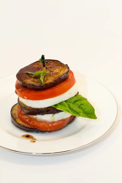 Eggplant with mozzarella cheese, tomatoes and basil — Stock Photo, Image