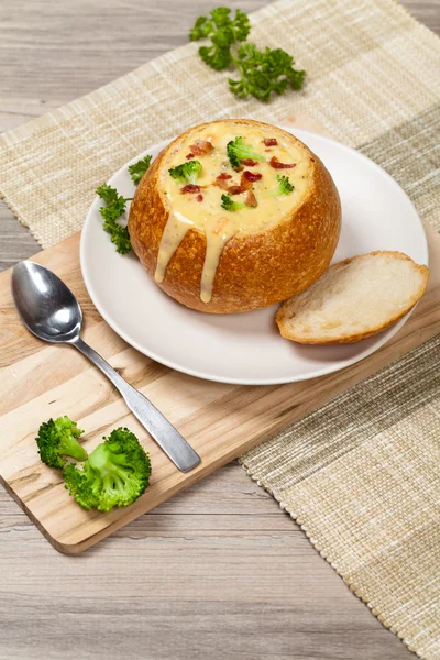 Sourdough bread bowl filled with broccoli cheese soup — Stock Photo, Image
