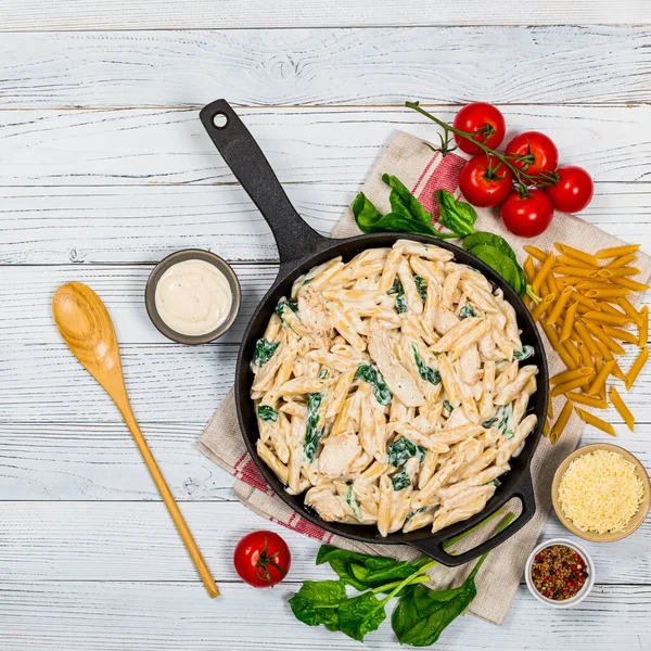 Chicken Alfredo Parmesan Penne Pasta Spinach White Wooden Background Top — Foto Stock