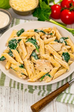 Ispanaklı tavuk Alfredo Parmesan Penne Makarnası. Seçici odak.