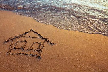 House painted on the sand clipart