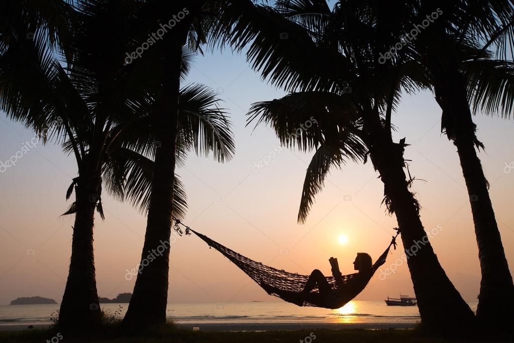 Sunset in hammock on the beach — Stock Photo © anyaberkut 22357005