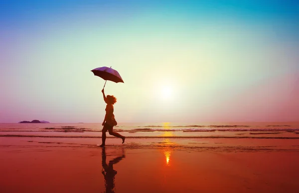 Woman jumping with umbrella — Stock Photo, Image