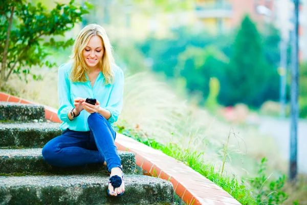 Happy smiling girl writing a message — Stock Photo, Image