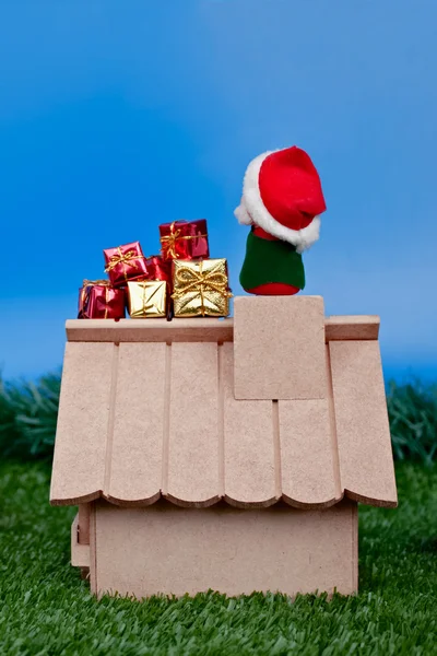 Back view - Santa Claus on roof and gifts — Stock Photo, Image