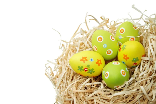 Colored Easter eggs into a nest — Stock Photo, Image