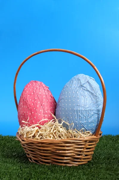 Easter eggs and wicker basket on a studio garden — Stock Photo, Image