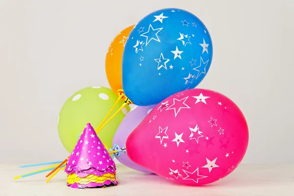 Party balloons and hats — Stock Photo, Image