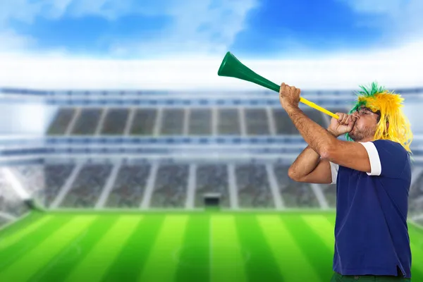 Brazilian fan at stadium playing vuvuzela — Stock Photo, Image