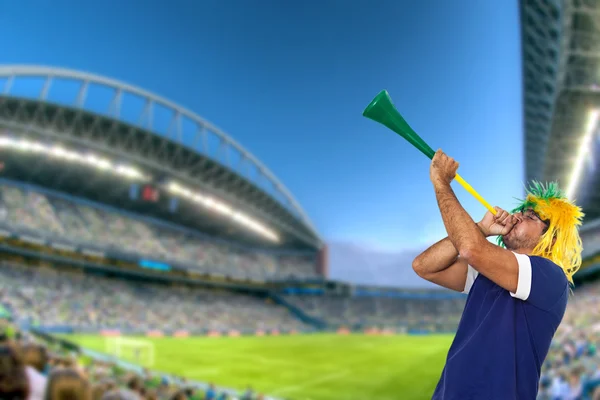 Brazilian fan at stadium playing vuvuzela — Stock Photo, Image