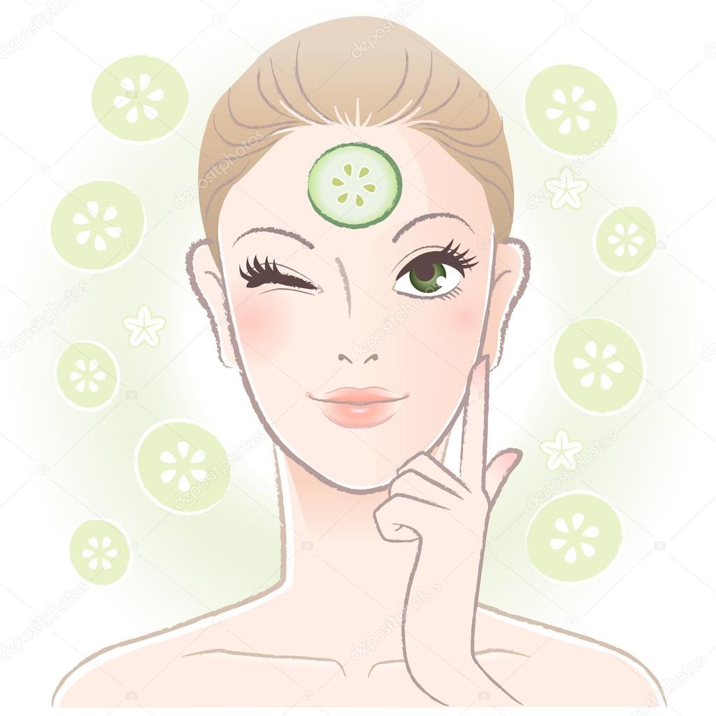 Pretty woman applying cucumber slice mask on her forehead