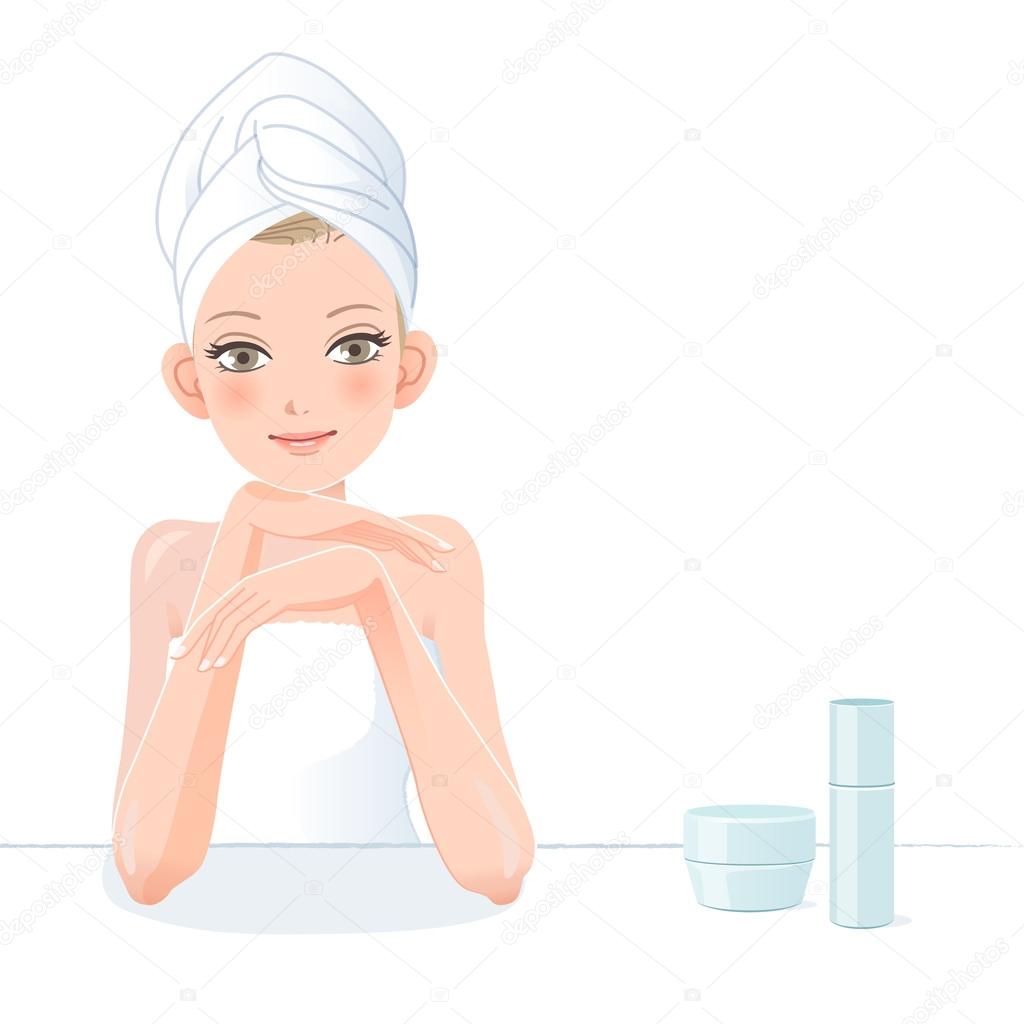 Pretty woman in towel smiling with skincare cosmetics