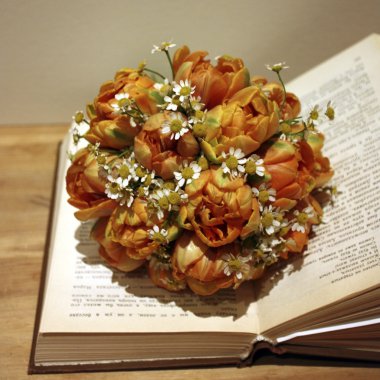 An open book with a bouquet of flowers clipart