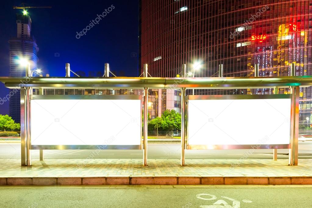 Blank billboard on bus stop at night