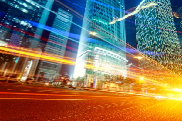 The light trails on the modern building background in shanghai china — Stock Photo, Image