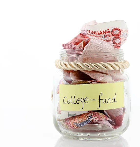 A lot of money in a glass bottle labeled :College fund — Stock Photo, Image
