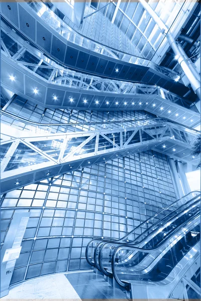 Blue moving escalator in the office hall perspective view — Stock Photo, Image