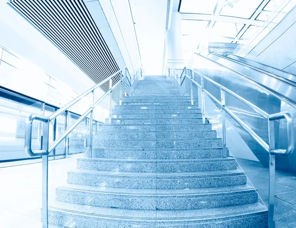 Blue moving escalator in the office hall perspective — стоковое фото