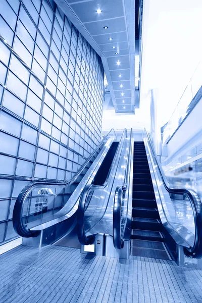 Blue moving escalator in the office hall perspective view Stock Picture