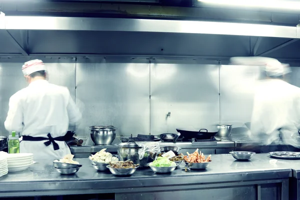 Motion chefs of a restaurant kitchen — Stock Photo, Image