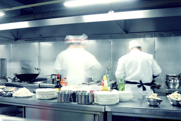 Motion chefs of a restaurant kitchen — Stock Photo, Image