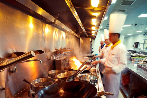 Motion chefs of a restaurant kitchen — Stock Photo, Image