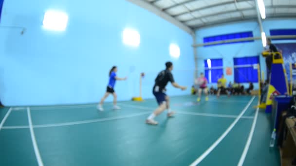 Terrains de badminton avec des joueurs en compétition en salle . — Video