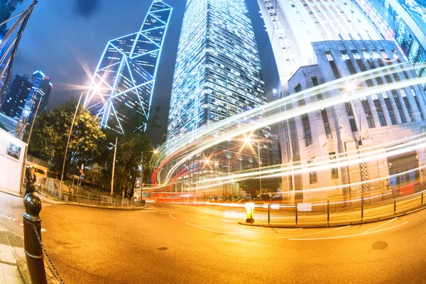 The light trails on the modern building background in hongkong c — Stock Photo, Image