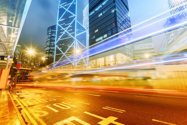 The light trails on the modern building background in hongkong c — Stock Photo, Image