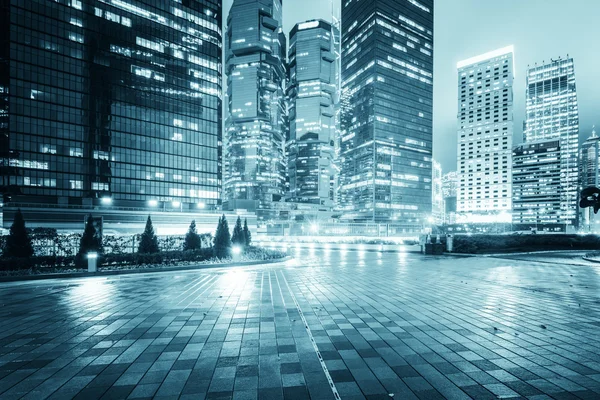 The light trails on the modern building background in hongkong c — 图库照片