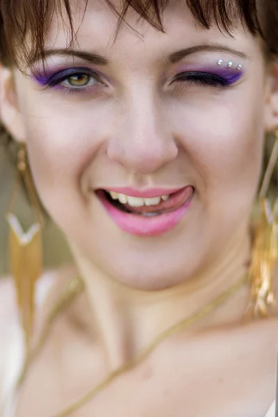 Portrait of a beautiful woman who winks in the frame — Stock Photo, Image