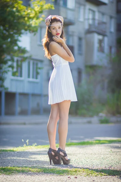 Portrait of a beautiful brunette girl in a short dress with bright makeup — Stock Photo, Image