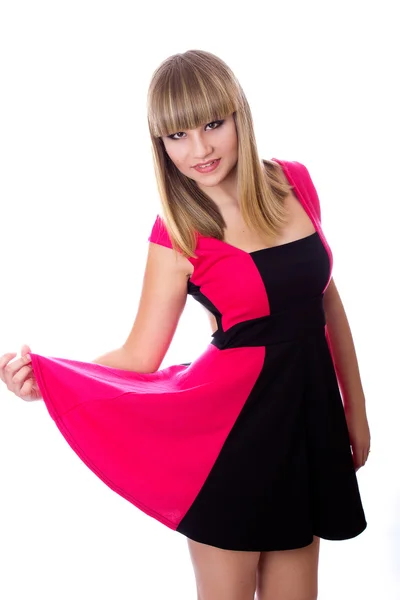 Studio portrait of a beautiful young blonde woman with short hair and a professional make-up in a short black and purple dress. — Stock Photo, Image